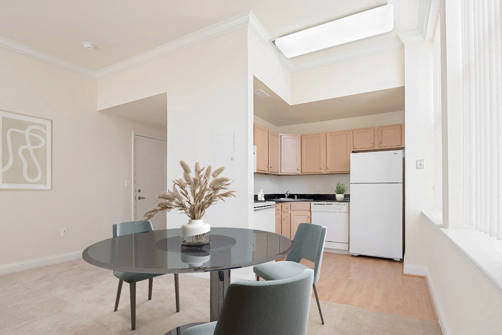 a dining room with a table and chairs and a kitchen