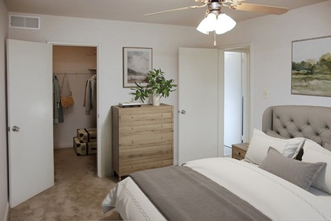 a bedroom with a bed and a dresser and a closet
