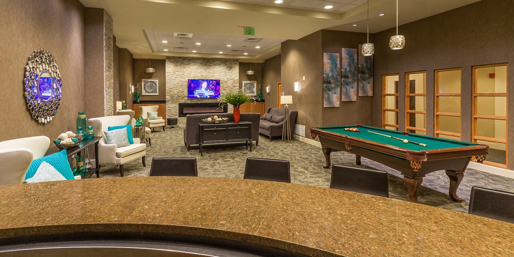 a clubhouse with a pool table and a bar