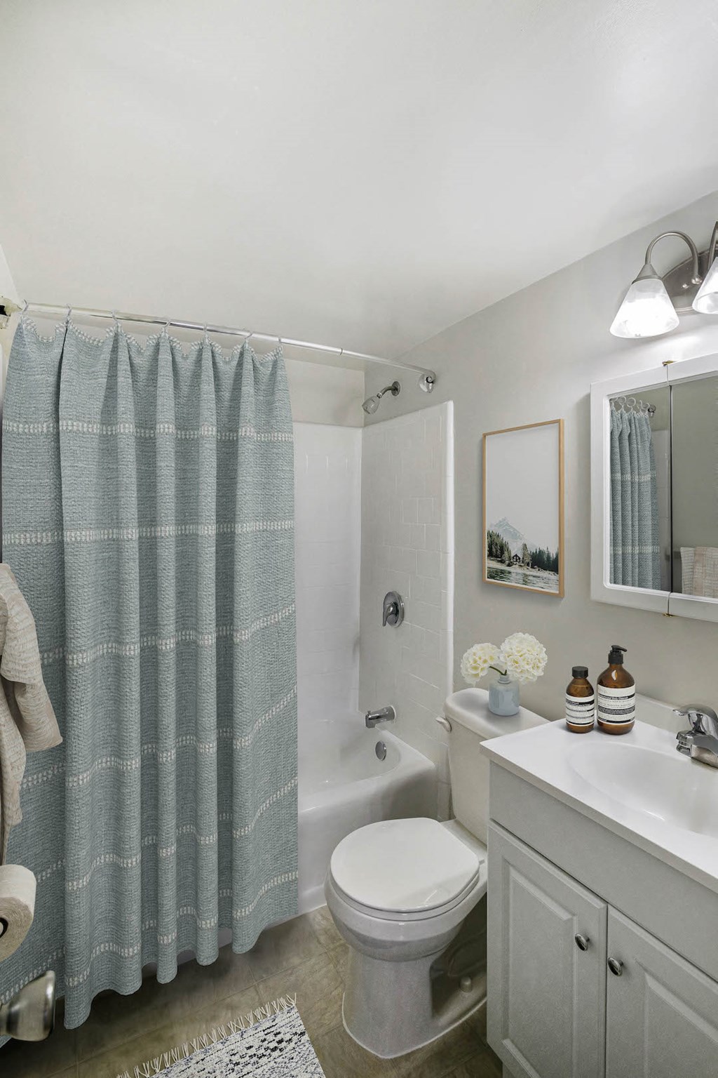 a bathroom with a shower curtain and a toilet and a sink