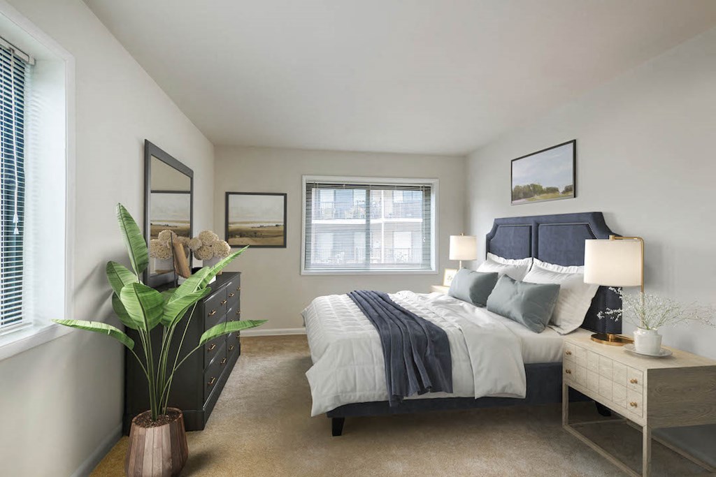 a bedroom with a bed and a dresser and a window