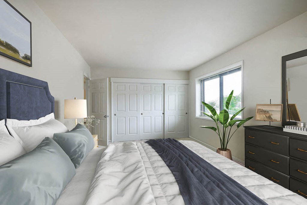 a bedroom with a large bed and a window