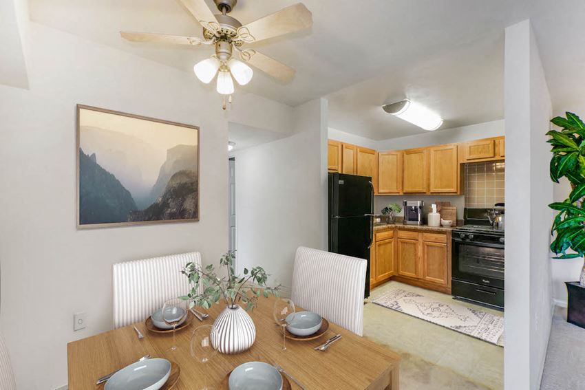 a dining room table with a kitchen in the background