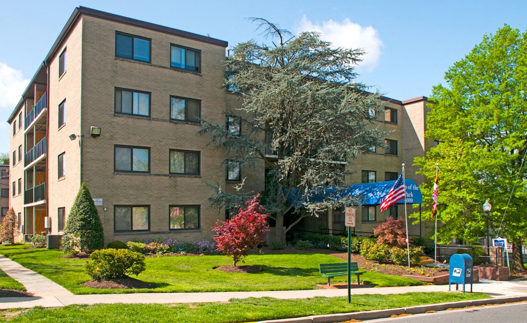 an apartment building with an flag in front of it