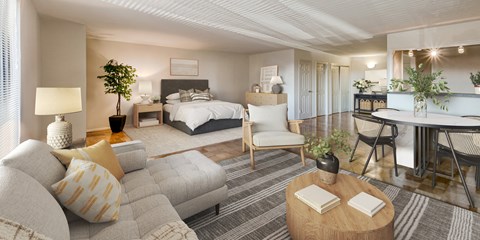 a bedroom with a bed and a living room with a couch and a table