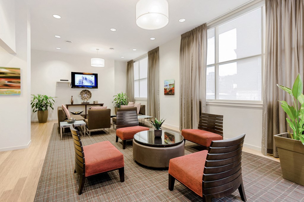 a lounge area with chairs and a table in a room