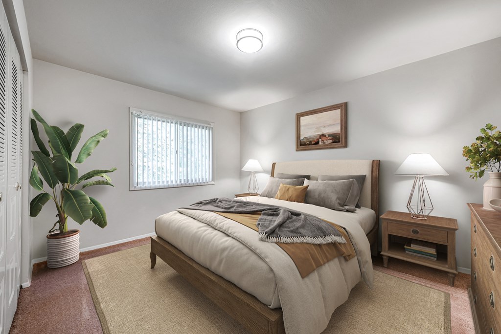 a bedroom with a large bed and a potted plant
