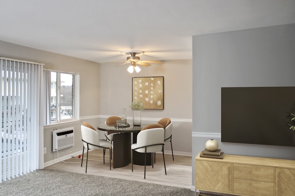 A modern dining room with a glass table and chairs.