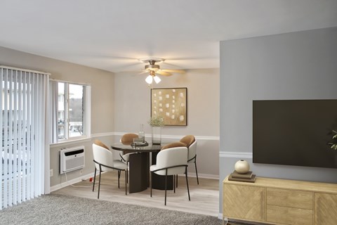 A modern dining room with a glass table and chairs.