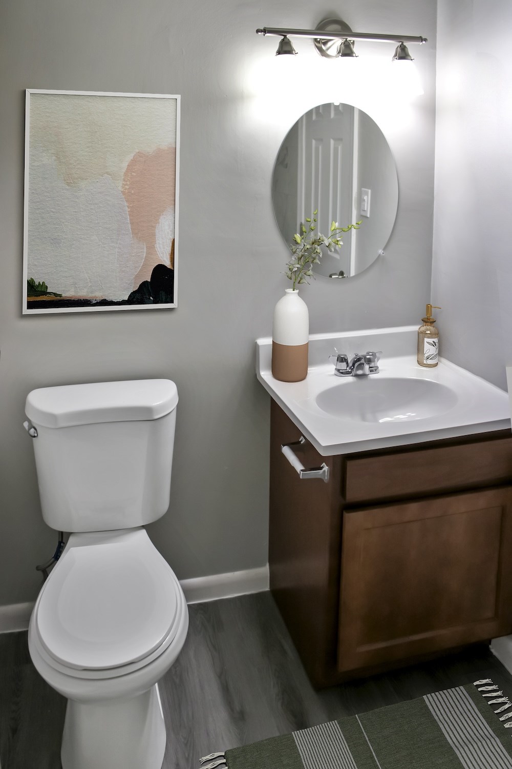 A white toilet sits next to a sink in a bathroom.