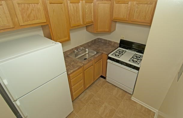 a small kitchen with a stove and a refrigerator