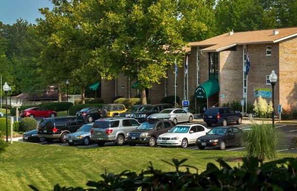 a parking lot full of cars in front of a building