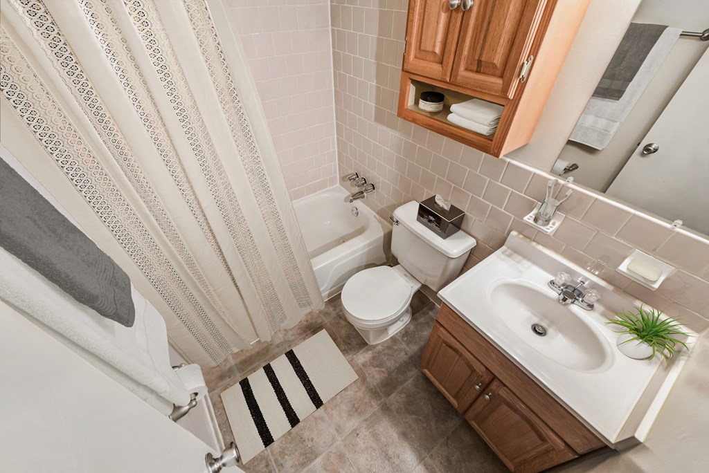 a small bathroom with a toilet sink and a shower