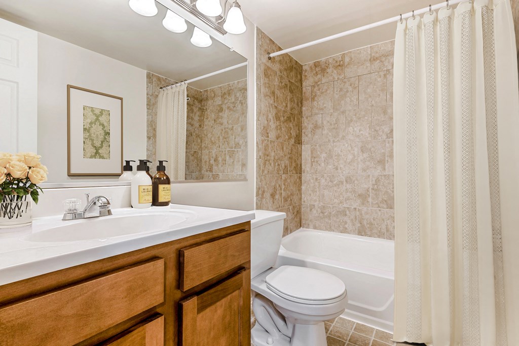 a bathroom with a sink toilet and a tub