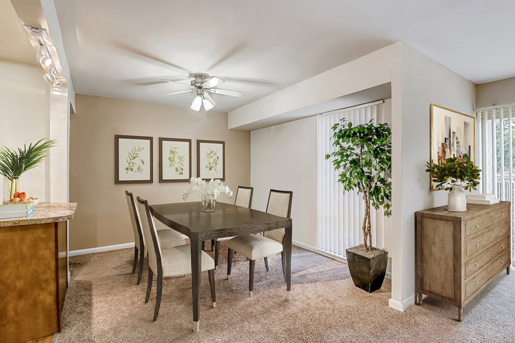 a dining room with a table and chairs and a ceiling fan