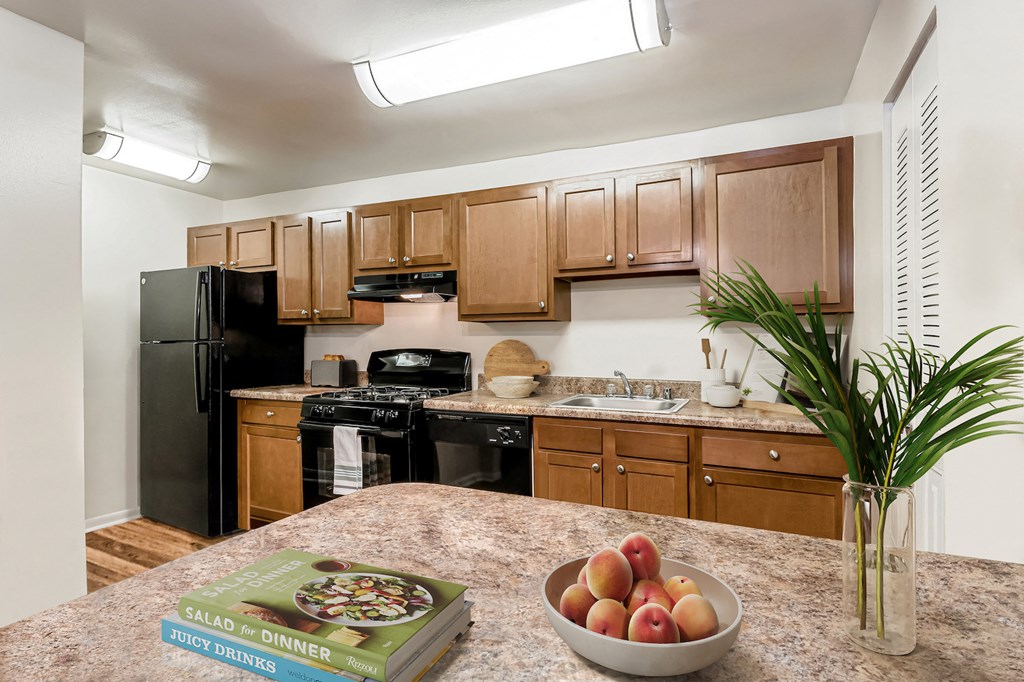 a kitchen with black appliances and wooden cabinets