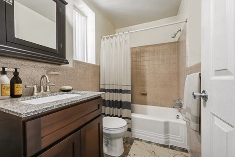 a bathroom with a sink and a toilet and a tub