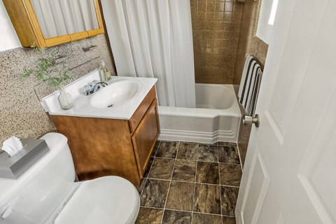 an image of a bathroom with a toilet sink and shower