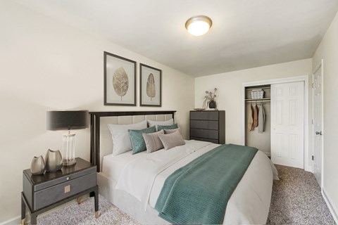 a bedroom with a large bed and a closet