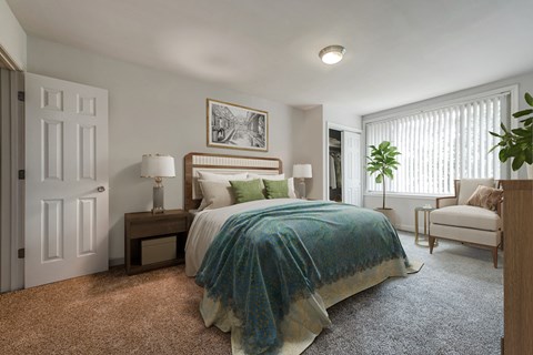 a bedroom with a bed and a chair and a window