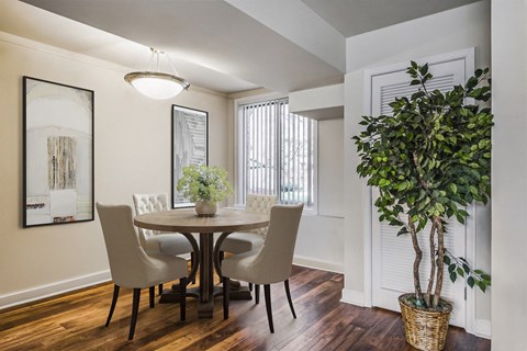 a dining room with a table and chairs and a window