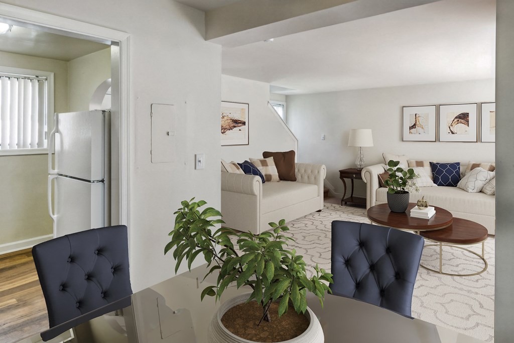 a living room and dining room with a table and chairs