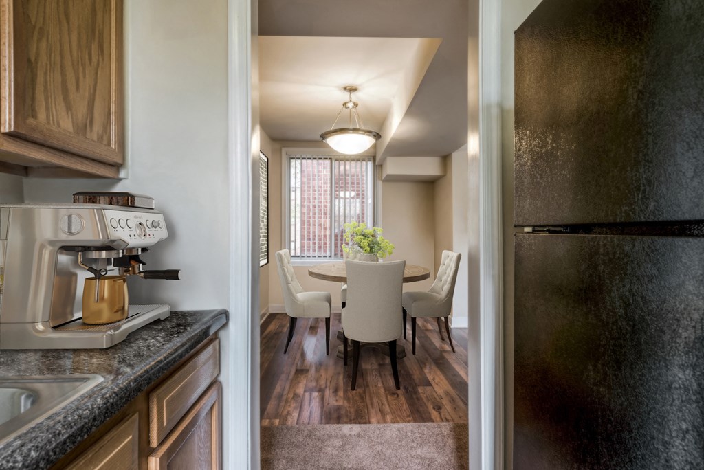 a kitchen and dining room with a table and chairs