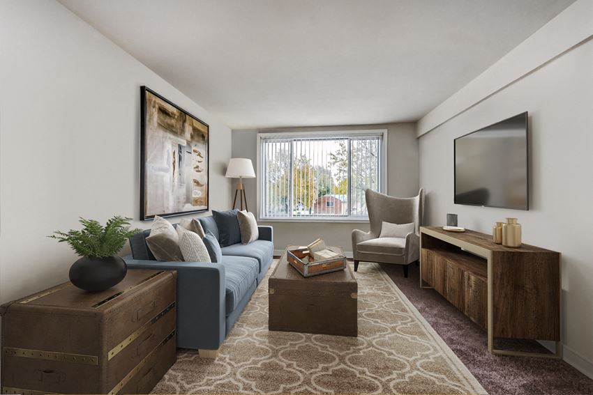 an apartment living room with a blue couch and a tv
