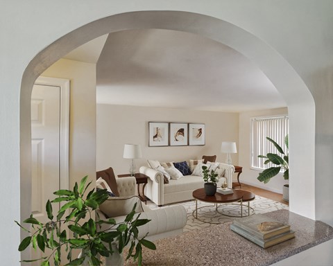 a living room with a white couch and a table