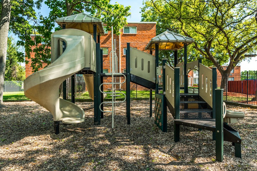a playground with a slide and other playground equipment
