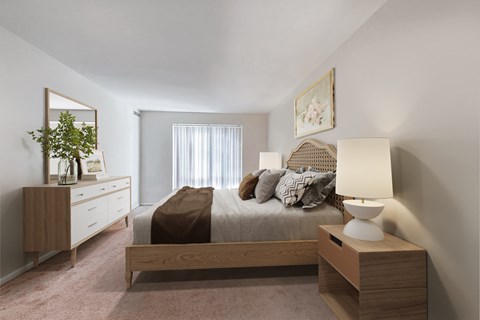 a bedroom with a bed and a dresser and a window