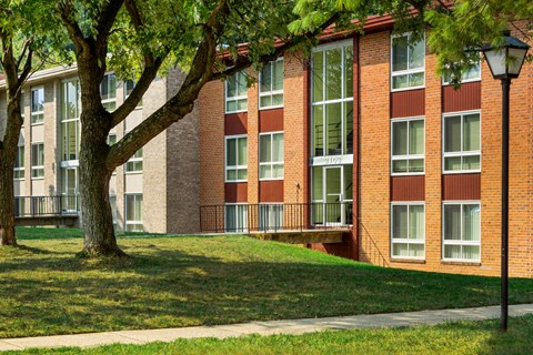 a brick building with a tree in front of it