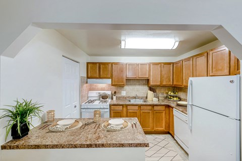 a kitchen with white appliances and wooden cabinets