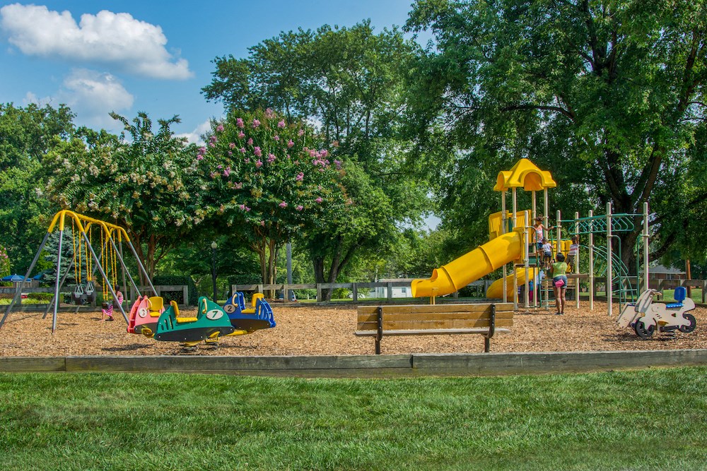 a playground with a large yellow slide and other playground equipment