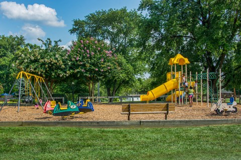 a playground with a large yellow slide and other playground equipment