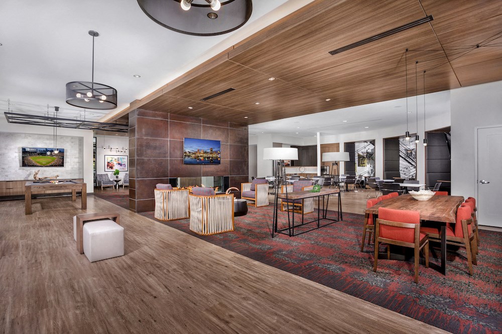 a living room and dining room with a table and chairs