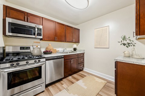 a kitchen with stainless steel appliances and wooden cabinets