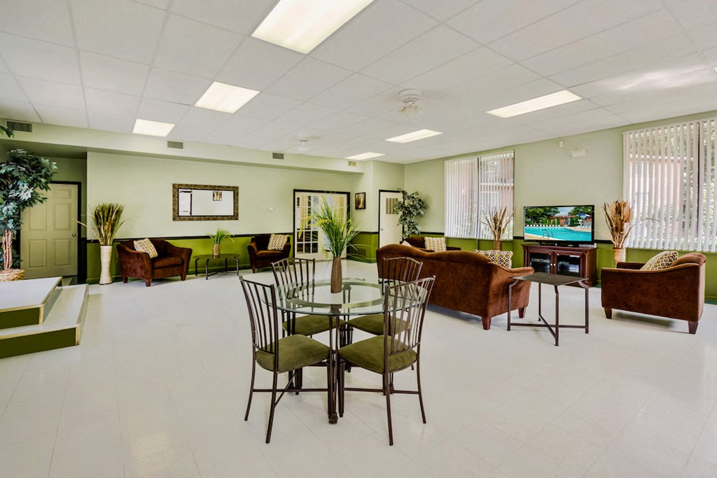 a living room with a table and chairs and a television