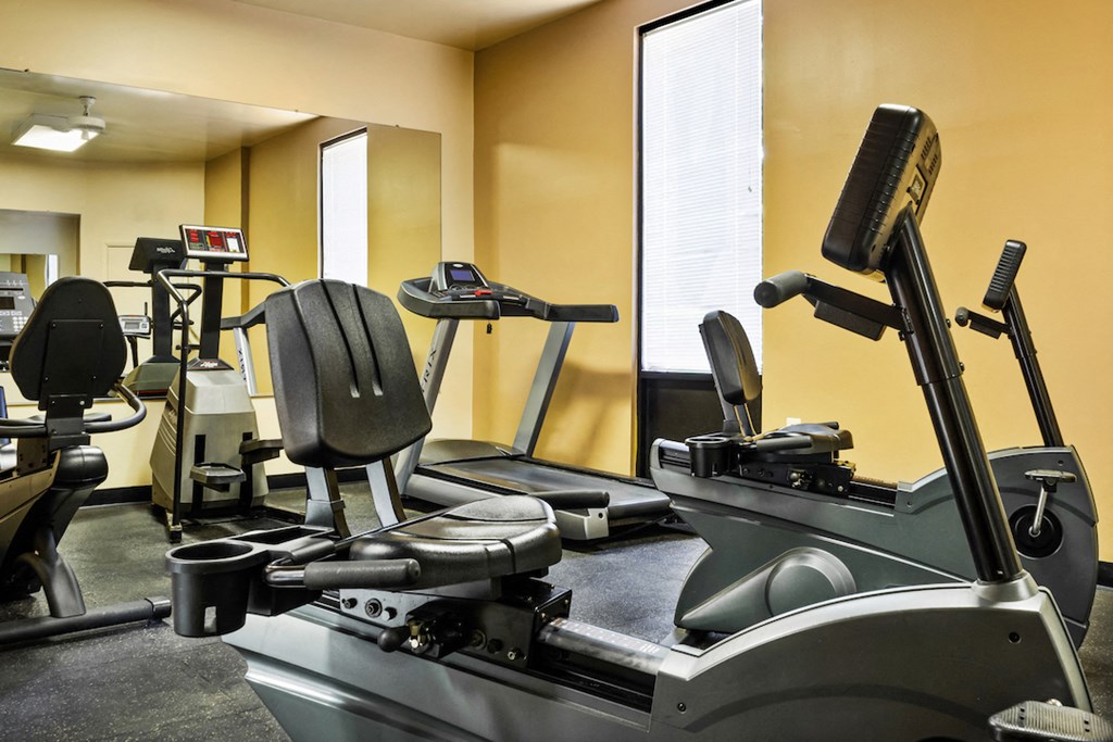 a gym with treadmills and other exercise equipment