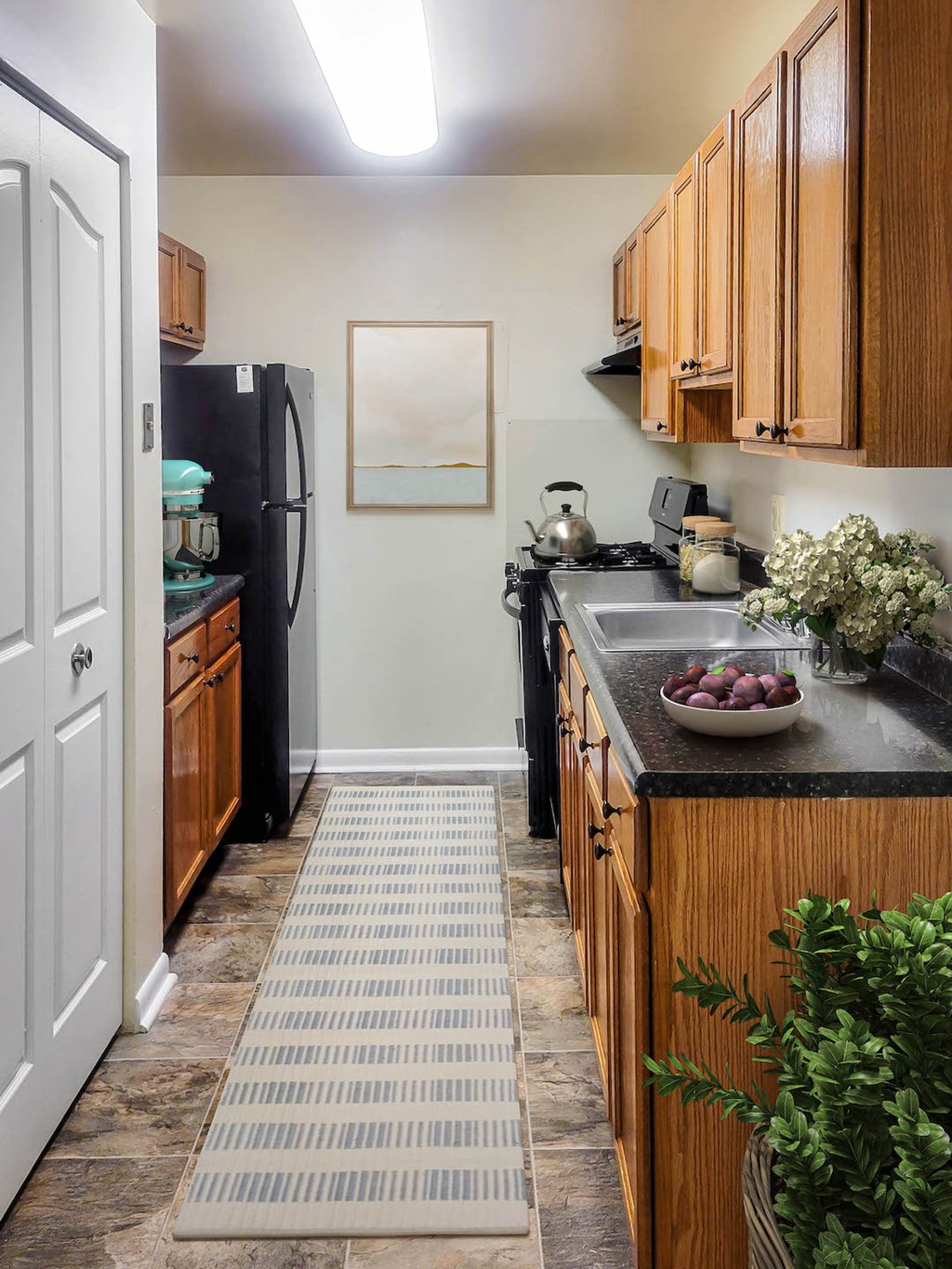 a kitchen with black appliances and wooden cabinets
