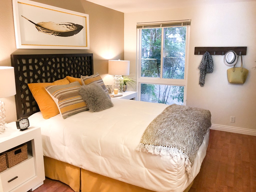 a bedroom with a large bed and a window