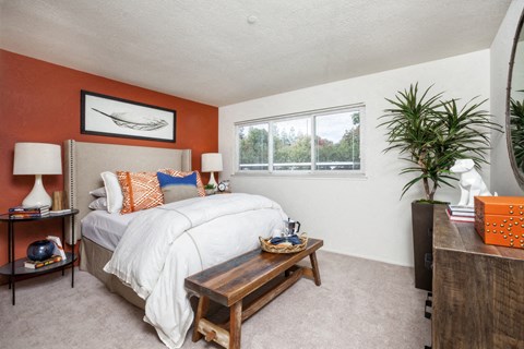 a bedroom with a bed and a window