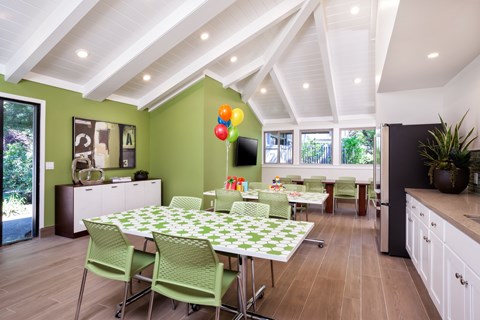 A dining room with a table and chairs.
