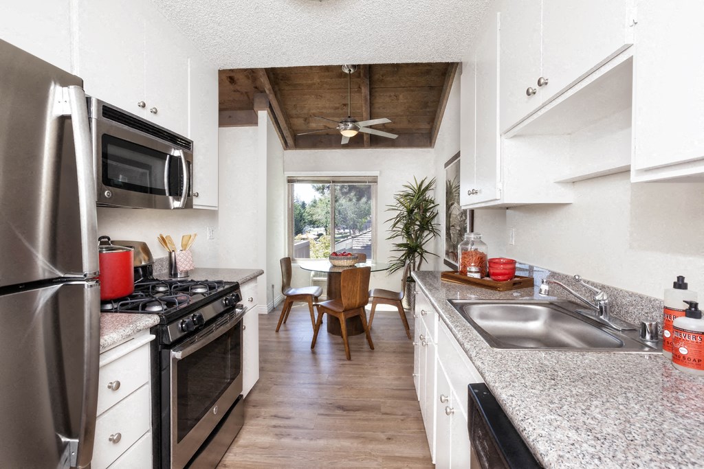 a kitchen with stainless steel appliances and granite counter tops