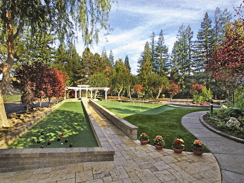 a garden with a pathway and grass and trees