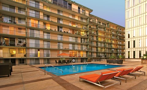 a swimming pool at a hotel in front of a building