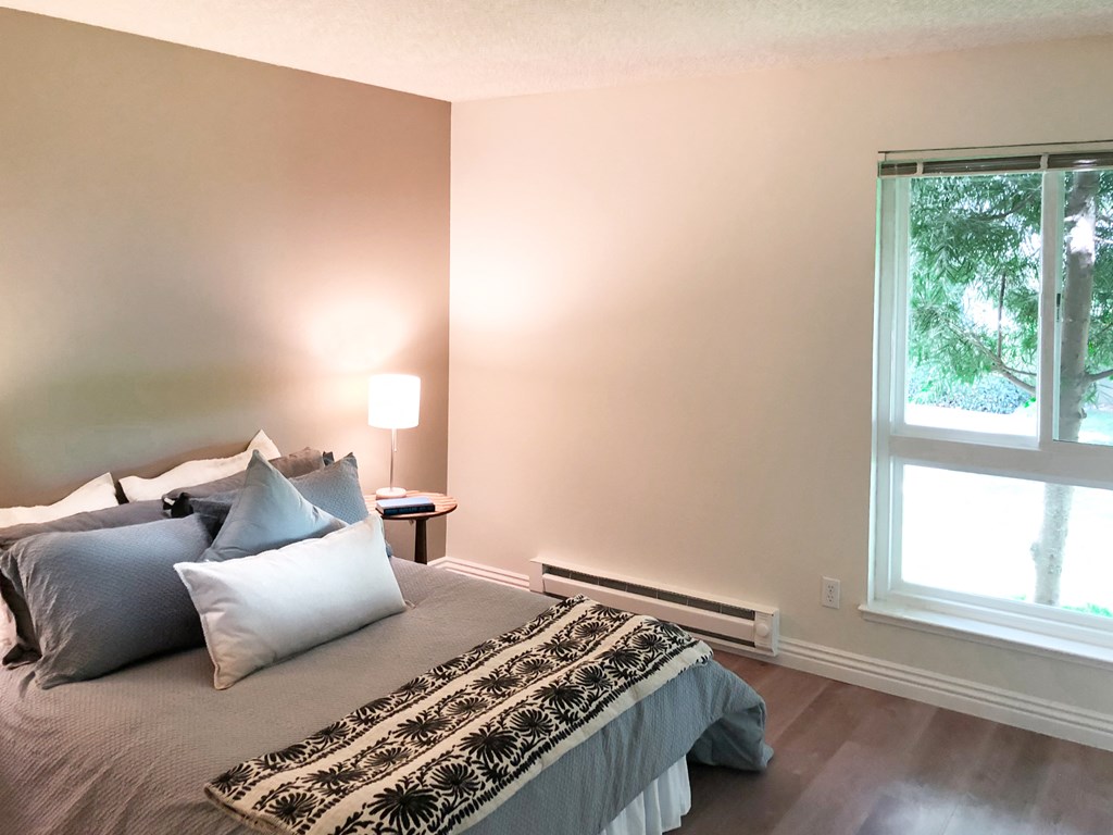 a bedroom with a bed and a window