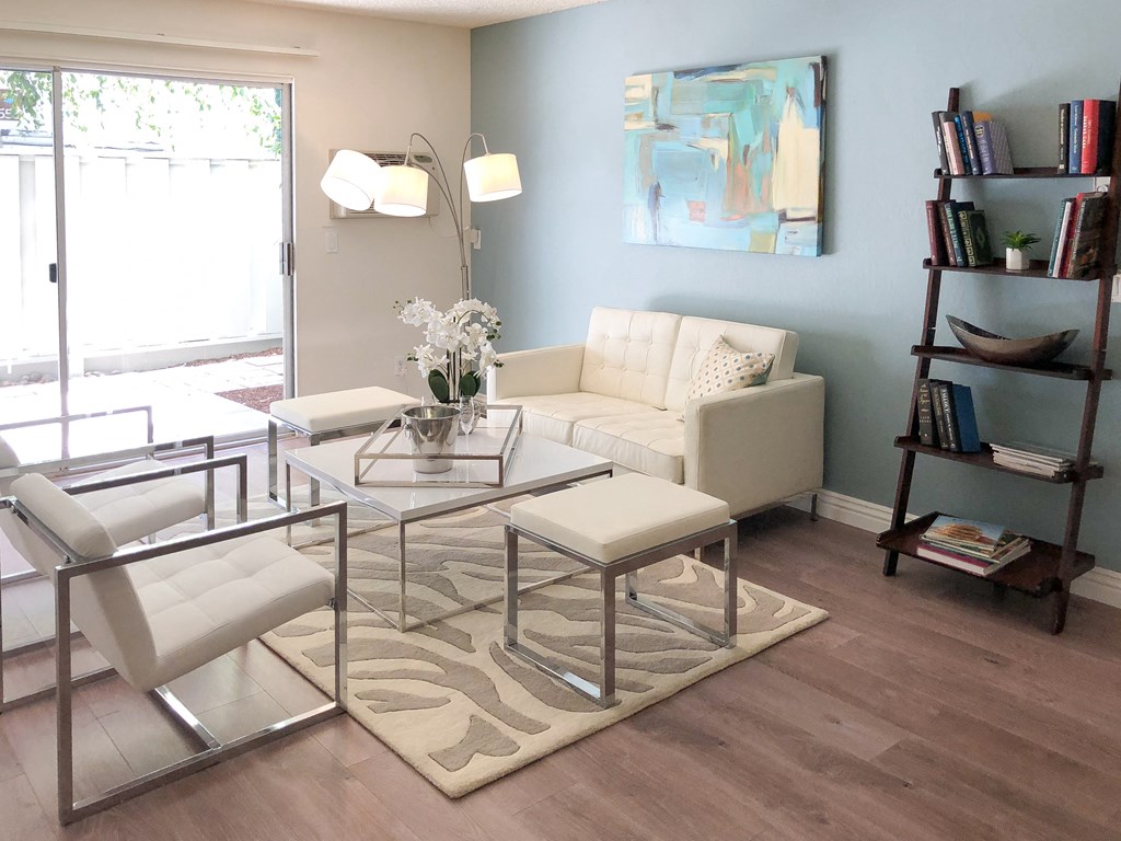 a living room with a glass table and a white couch