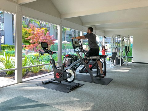 a man on a exercise bike in a gym