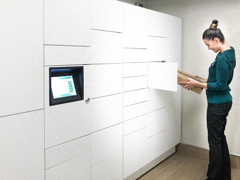 a woman standing in a room with a screen on the wall